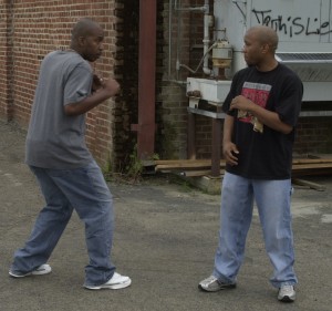 Two men fighting street fight